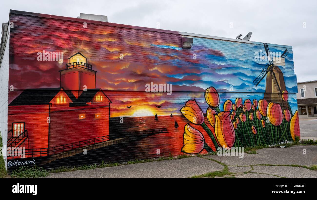 Sammy's Place mural (tulips, DeZwaan Windmill, sunset on the beach, Big Red lighthouse)., in Holland, Michigan. Artist, Chris Garcia Stock Photo