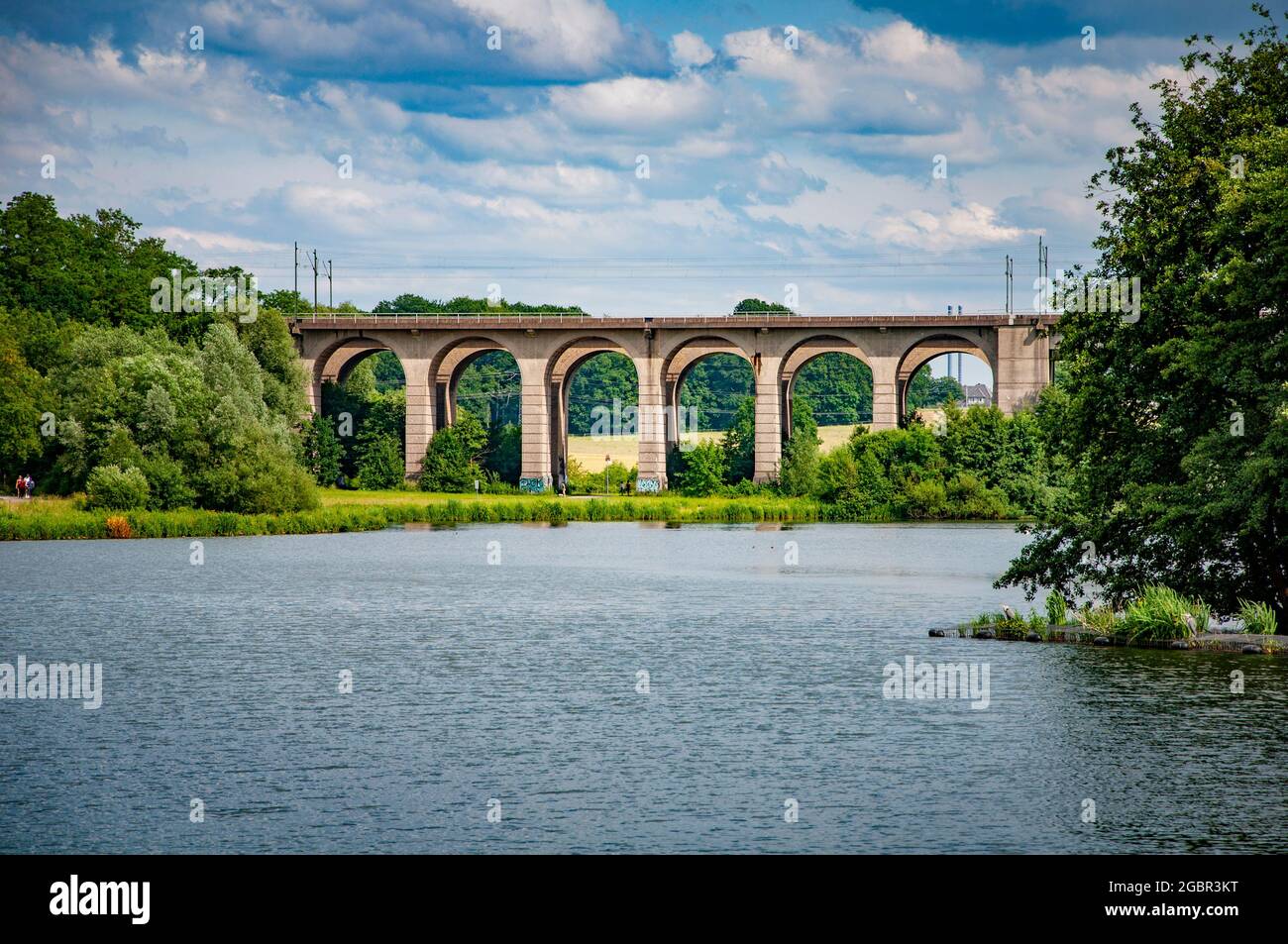 BIELEFELD, GERMANY. JUNE 20, 2021. Loheide park. Lake view to the big railway bridge. Stock Photo