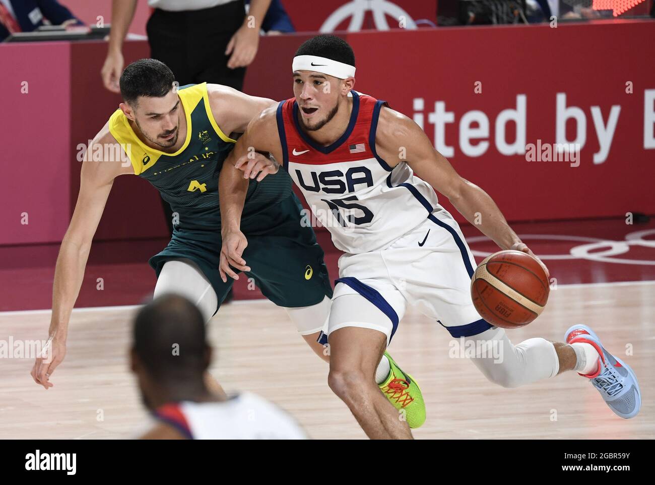 Tokyo, Japan. 05th Aug, 2021. United States' Devin Booker (R) is closely  guarded by Australia's Chris Goulding during Men's Basketball semifinal at  the Tokyo 2020 Olympics, Thursday, August 5, 2021, in Tokyo,