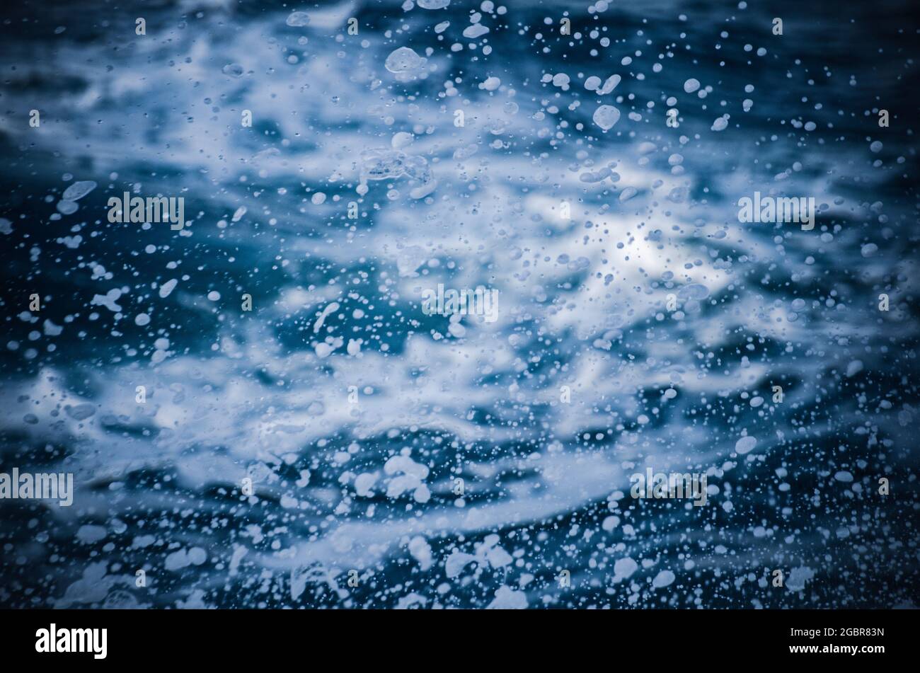 Abstract white foams come out from sea waves Stock Photo