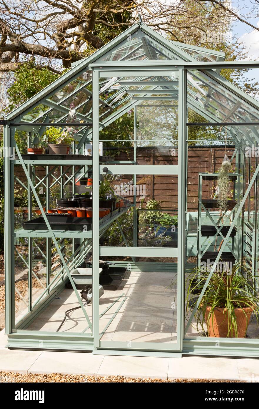 Exterior of a metal greenhouse in Spring Stock Photo