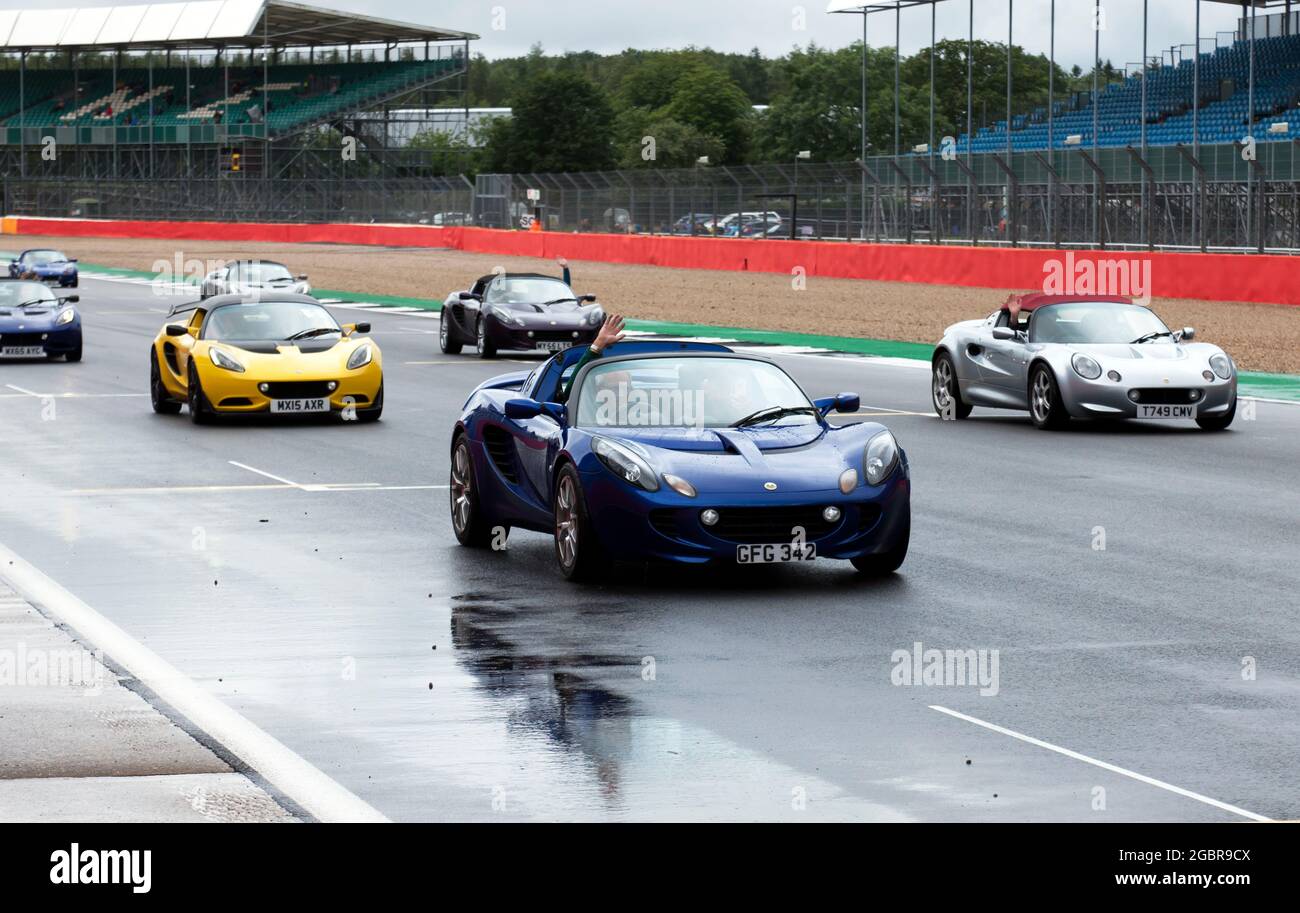 A track parade  passing down the Hamilton Straight, celebrating the 25th Anniversary of the Lotus Elise, on Sunday at the 2021 Silverstone Classic Stock Photo