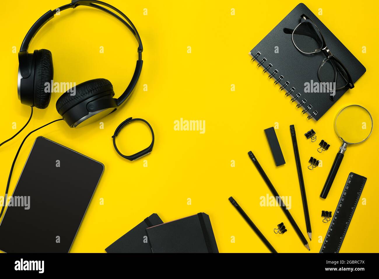 Work Objects Background Black objects from the office on a yellow background. Work and ...