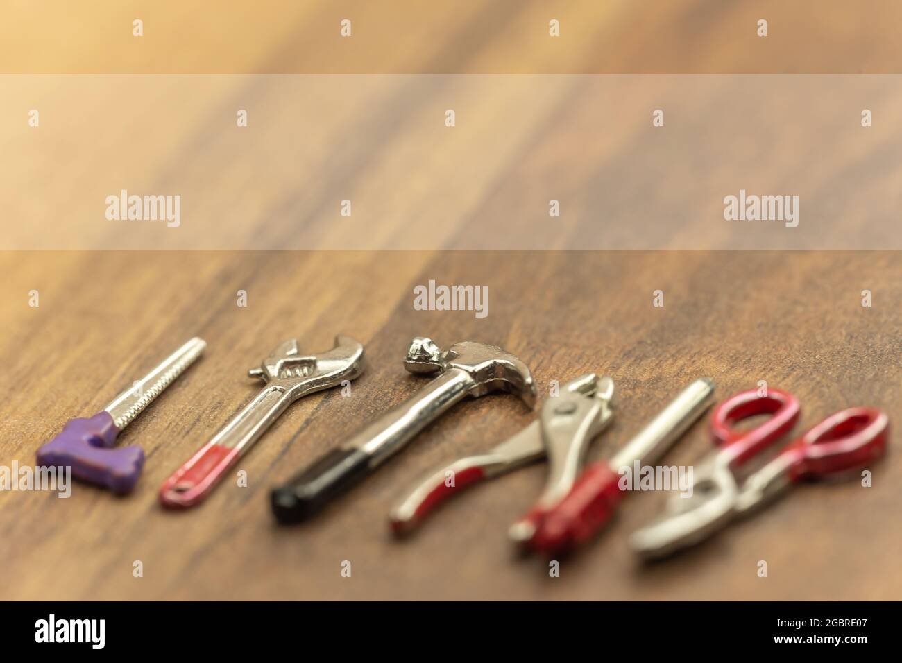 Crafting concept: A banner above miniature crafting tools. Text space. Stock Photo