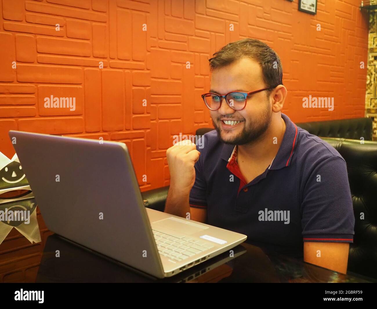 Close up smiling  man wearing glasses using laptop Stock Photo