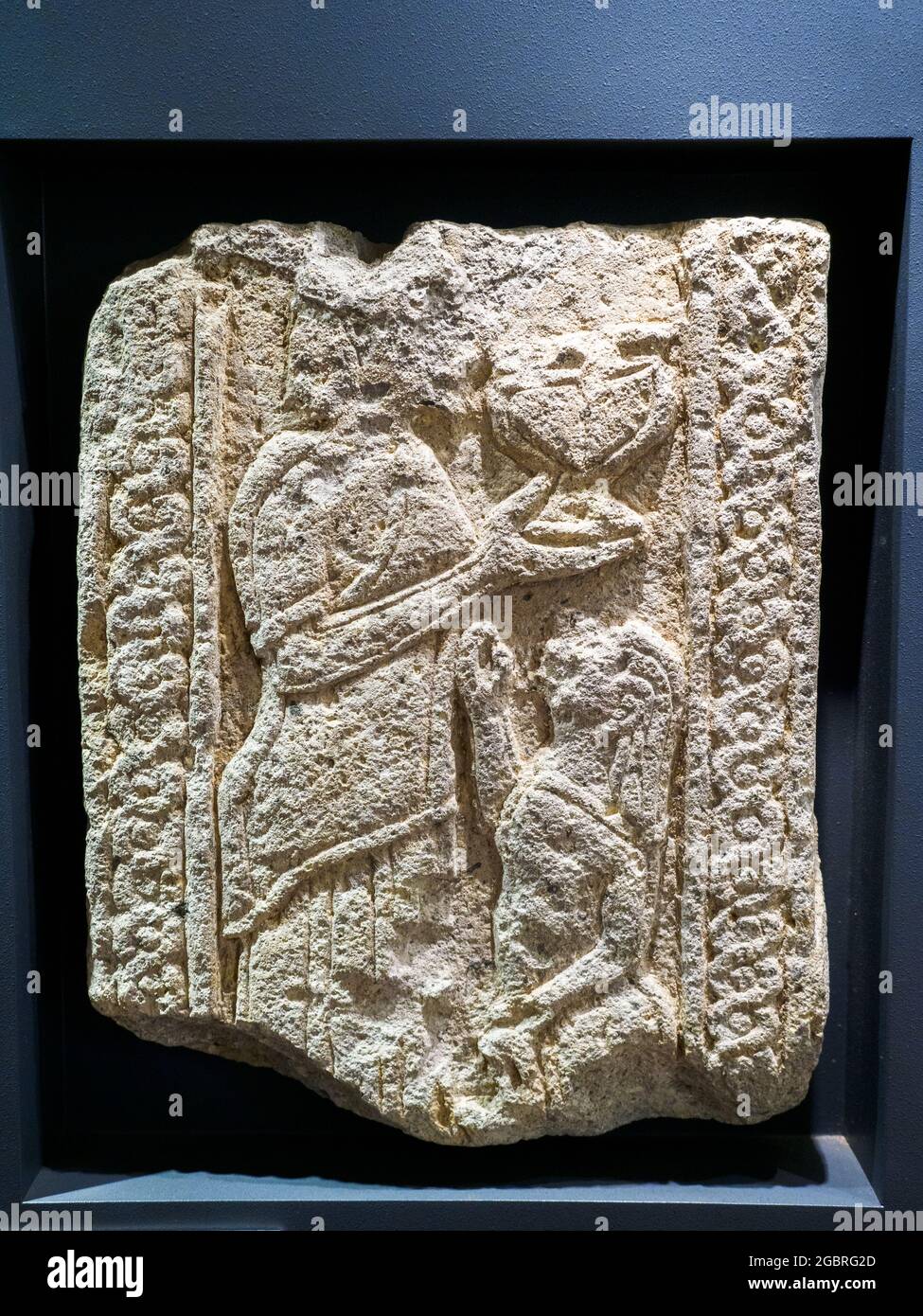 Slab depicting a standing male figure and cup in his right hand in front of a boy with outstretched arm from the Necropolis of Poggio Gallinaro (6th c Stock Photo