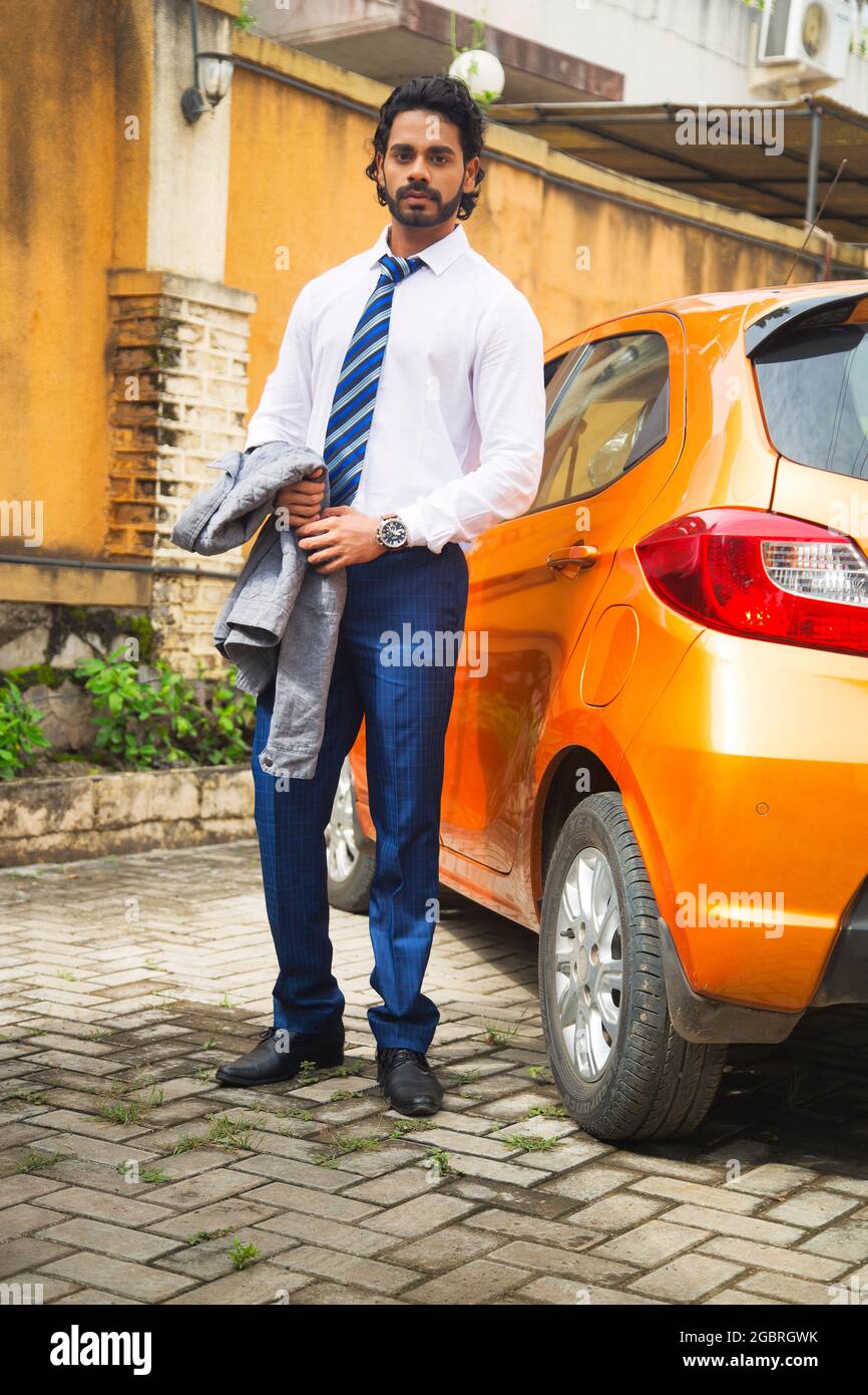 Young male model with yellow car Stock Photo