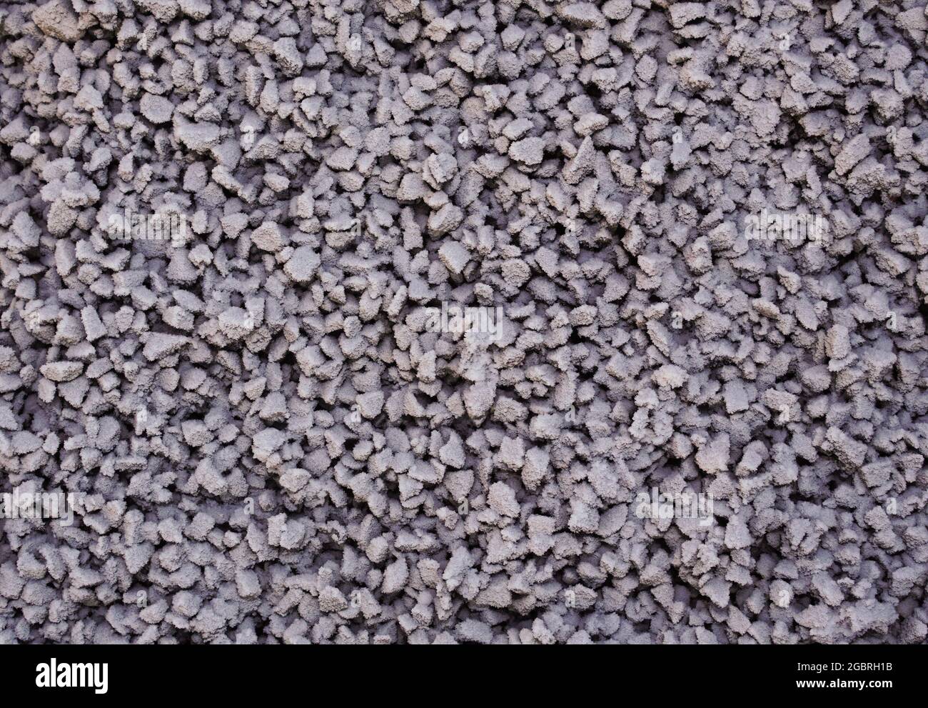 Small stones under the snow as background. Stock Photo