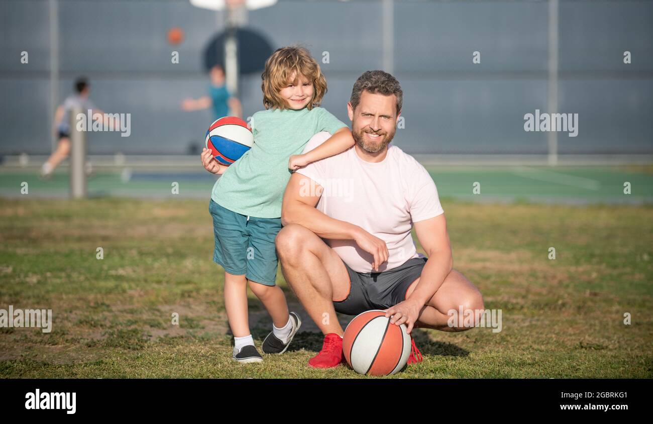 happy father and kid playing basketball with ball outdoor, sport Stock Photo