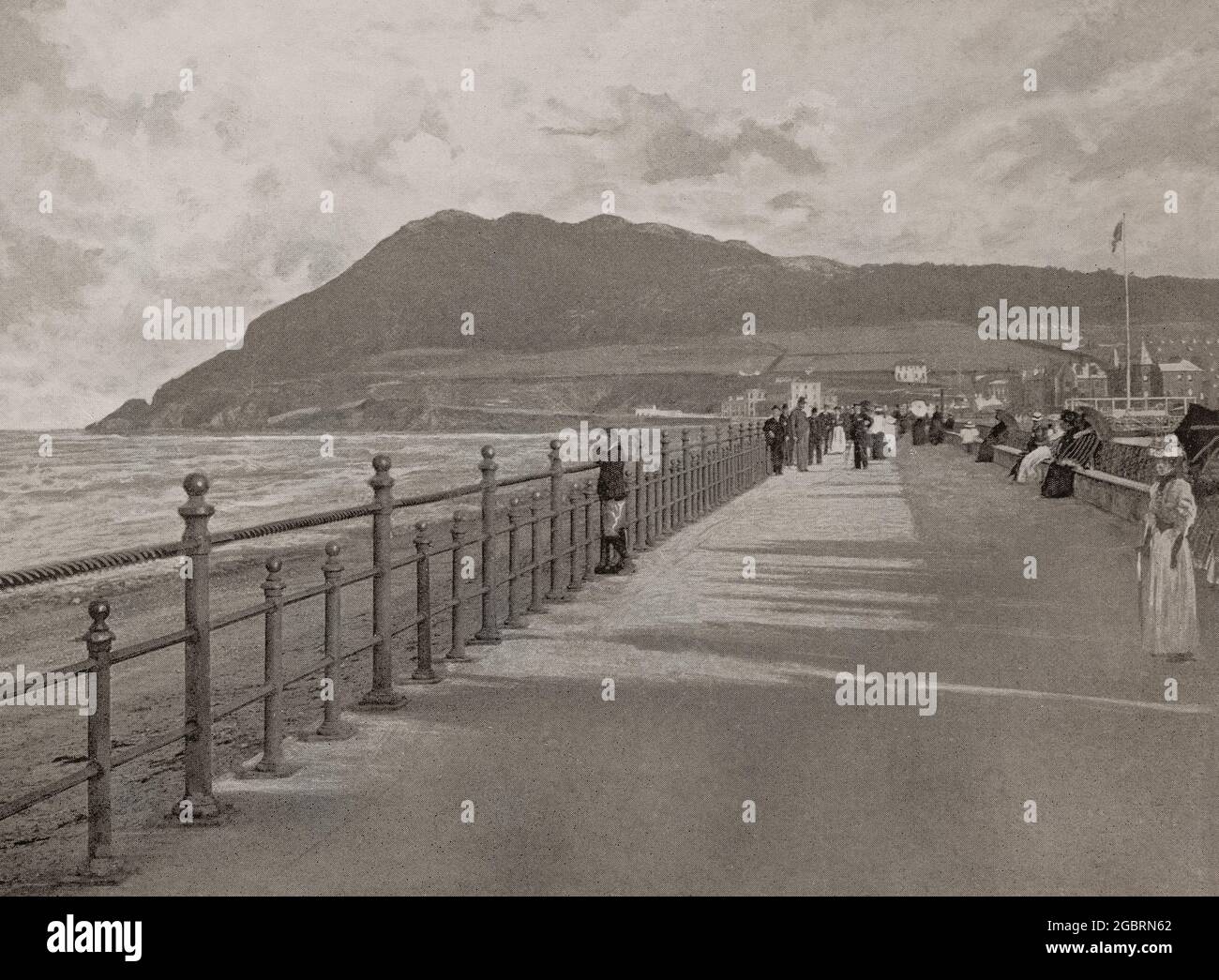A late 19th century view of the promenade in Bray in north County Wicklow, Ireland. In medieval times, it was a small manorial village on the southern border of the Pale, then during the latter part of the 18th century, the Dublin middle-classes began to relocate there.  The Dublin and Kingstown Railway was extended as far as Bray in 1854 and the town grew to become a seaside resort, with hotels and residential terraces built in the vicinity of the seafront. Stock Photo