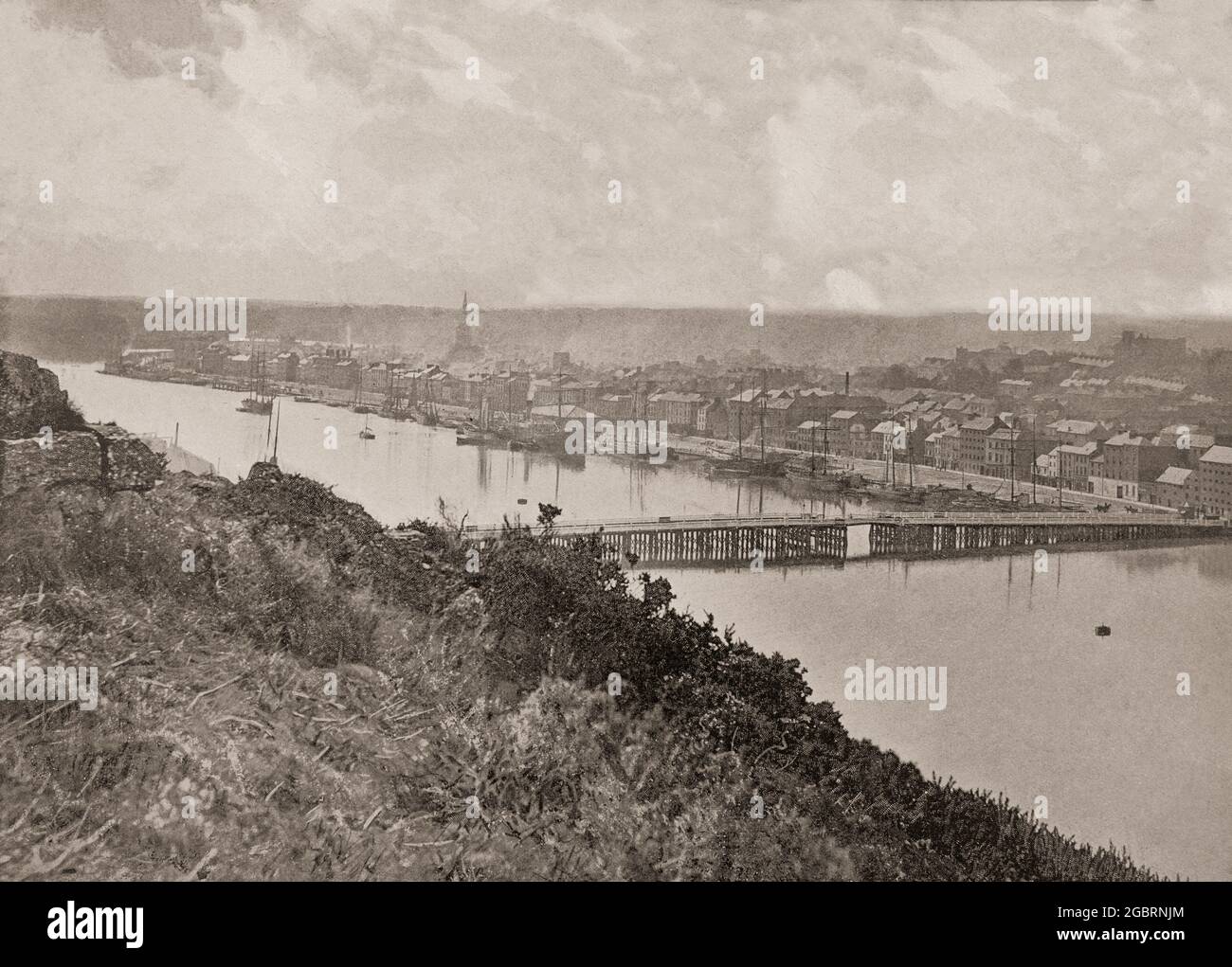A late 19th century aerial view of the bridge over the River Suir as it flows through Waterford, the oldest city in the Republic of Ireland. Timbertoes was a local name for a timber bridge which spanned the river between 1794 and 1910.It was built by the American bridge builder, Lemuel Cox, who designed a timber bridge using American oak and construction began in 1793 to open the following year. Surprisingly no opening was provided for tall river traffic, so a 12m wide drawbridge was added later. Stock Photo