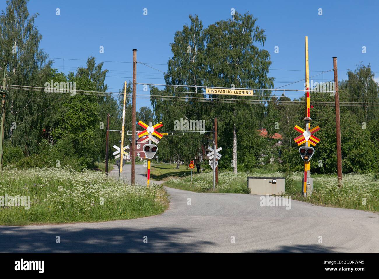 White light alert at a railway crossing. Ok to cross the railroad. Road this side. Stock Photo