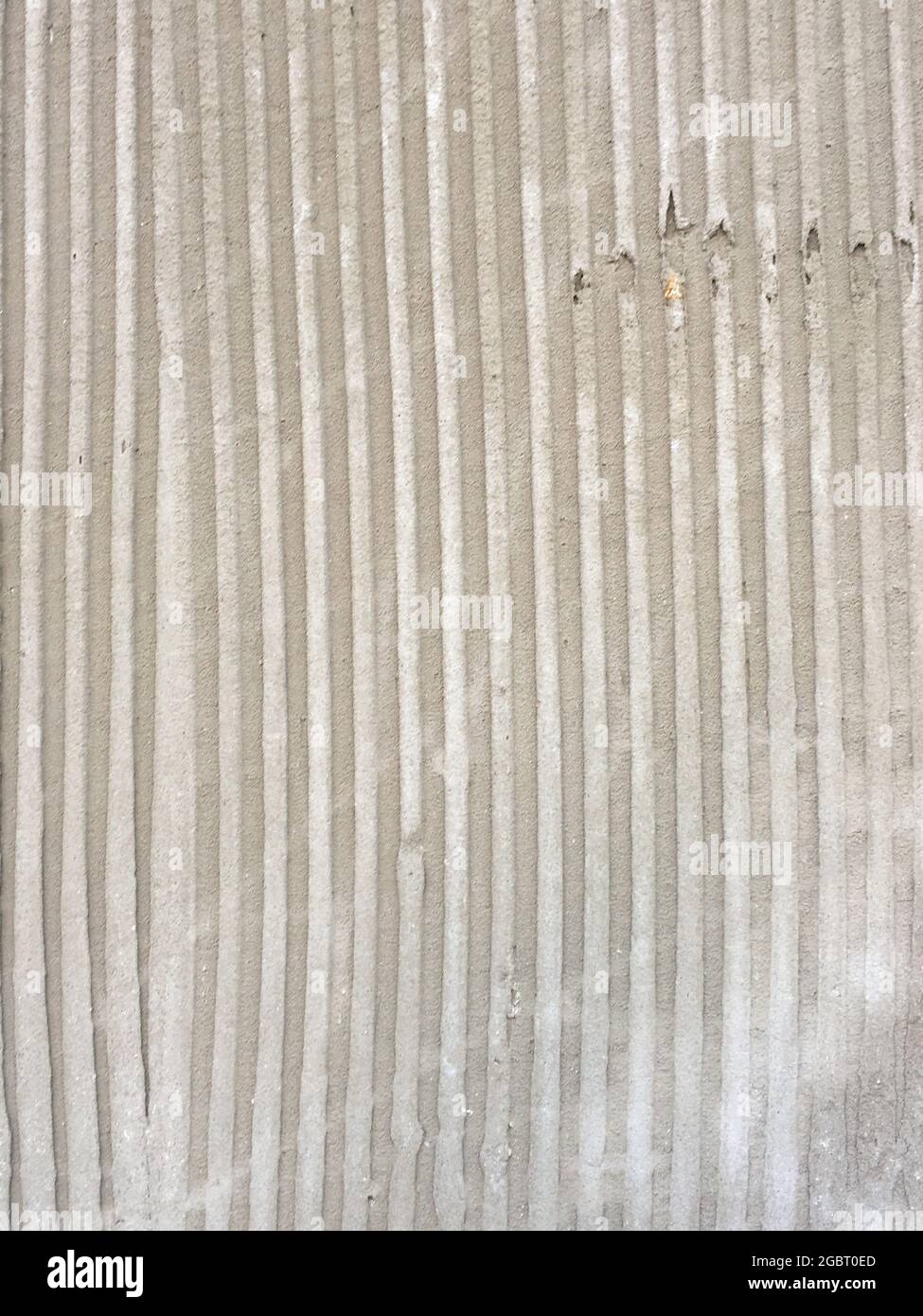 Texture of troweled cement with parallel vertical lines and grooves ...