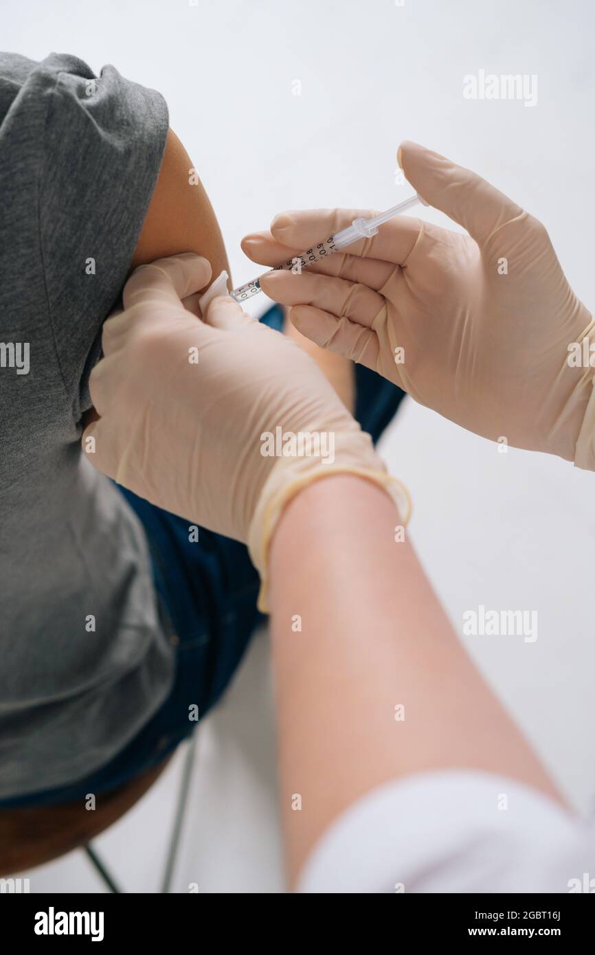Doctor giving injection shot in hi-res stock photography and images - Alamy