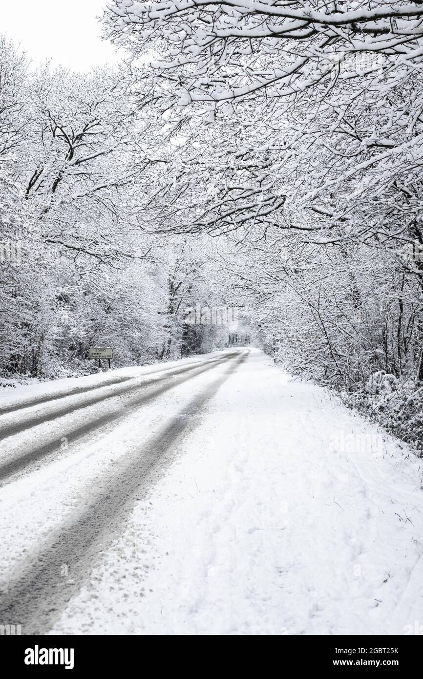 A country road covered in snow Stock Photo