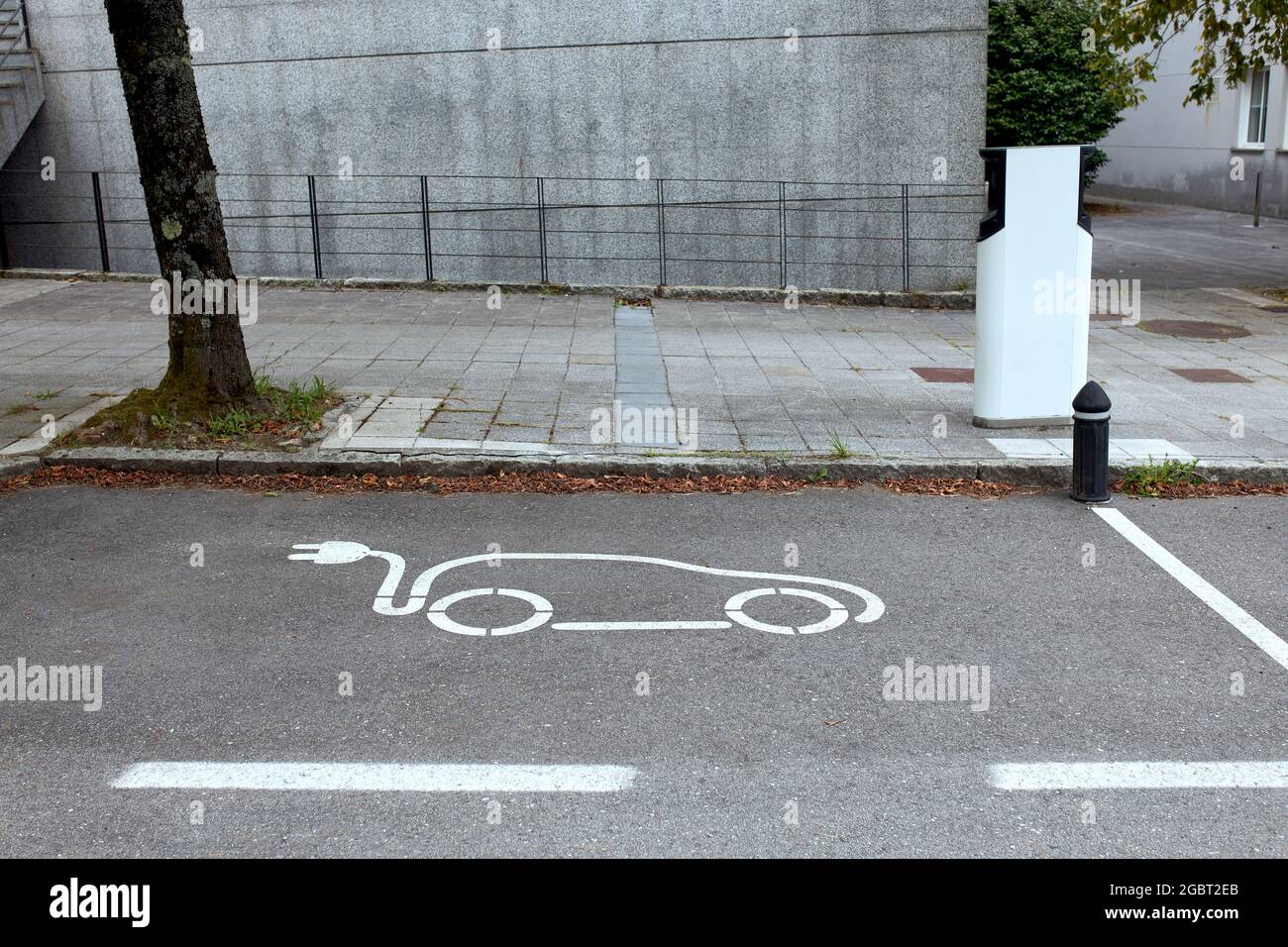 Electric vehicle parking with charging station Stock Photo Alamy