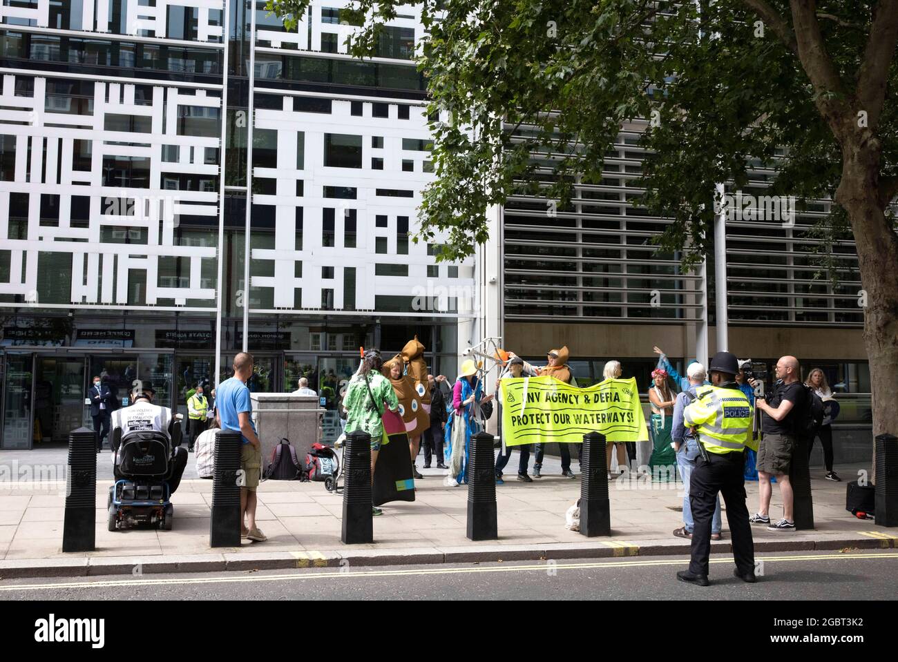 London, UK. 5th Aug, 2021. Members of Extinction Rebellion protest outside the Home Office and DEFRA. Members of Open water swimming and Angling groups protest against pollution in waterways.They want more action against global warming and the pollution of the rivers. Credit: Mark Thomas/Alamy Live News Stock Photo