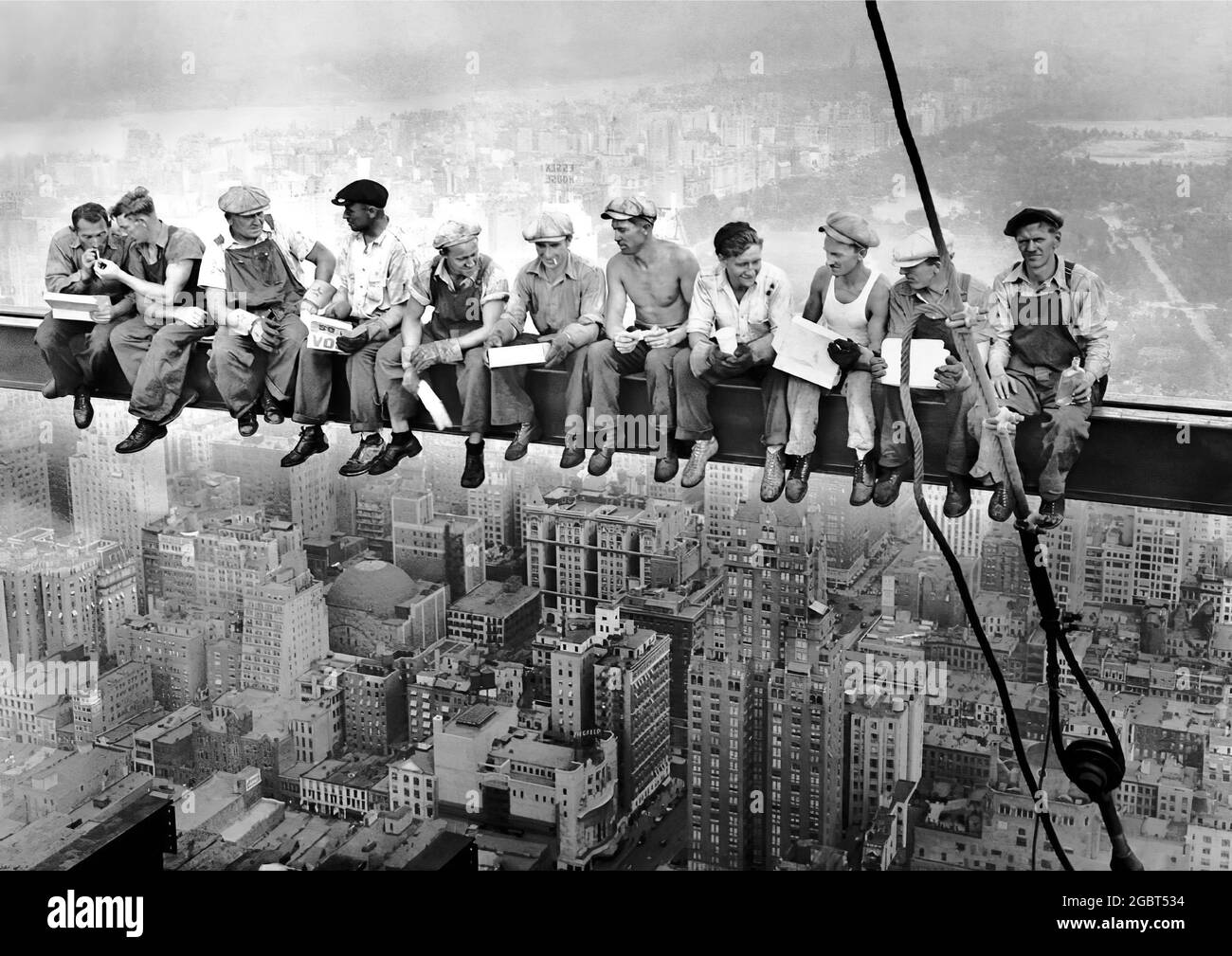 Lunch atop a Skyscraper-New York Construction Workers Lunching on a Crossbeam-is an iconic photograph taken atop the ironwork of 30 Rockefeller Plaza. Stock Photo