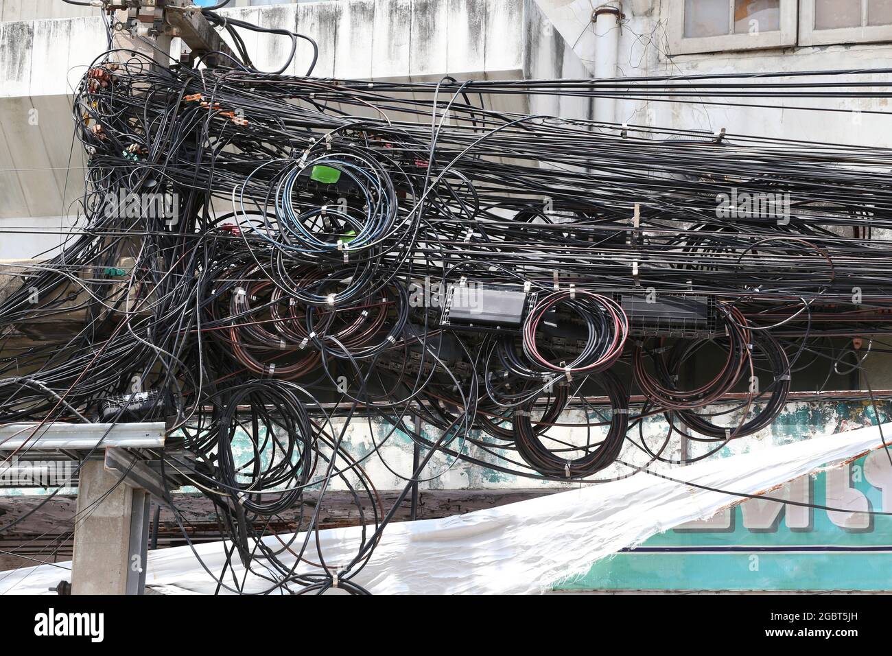 Power cable on the electric poles are tangled,Messy tangle signal line for design in your work concept. Stock Photo