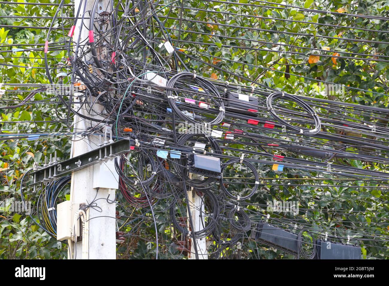 Cable wires on the electric poles are tangled,Messy signal line for design in your work concept. Stock Photo