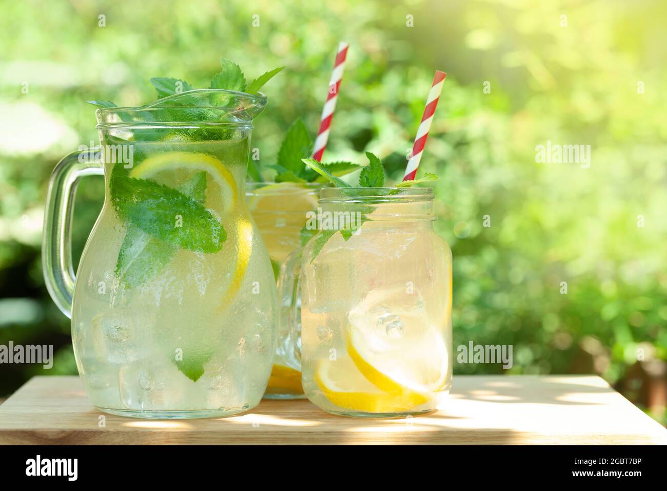Lemonade Outside Fresh homemade lemonade with lemon and mint. Outdoor garden table on ...