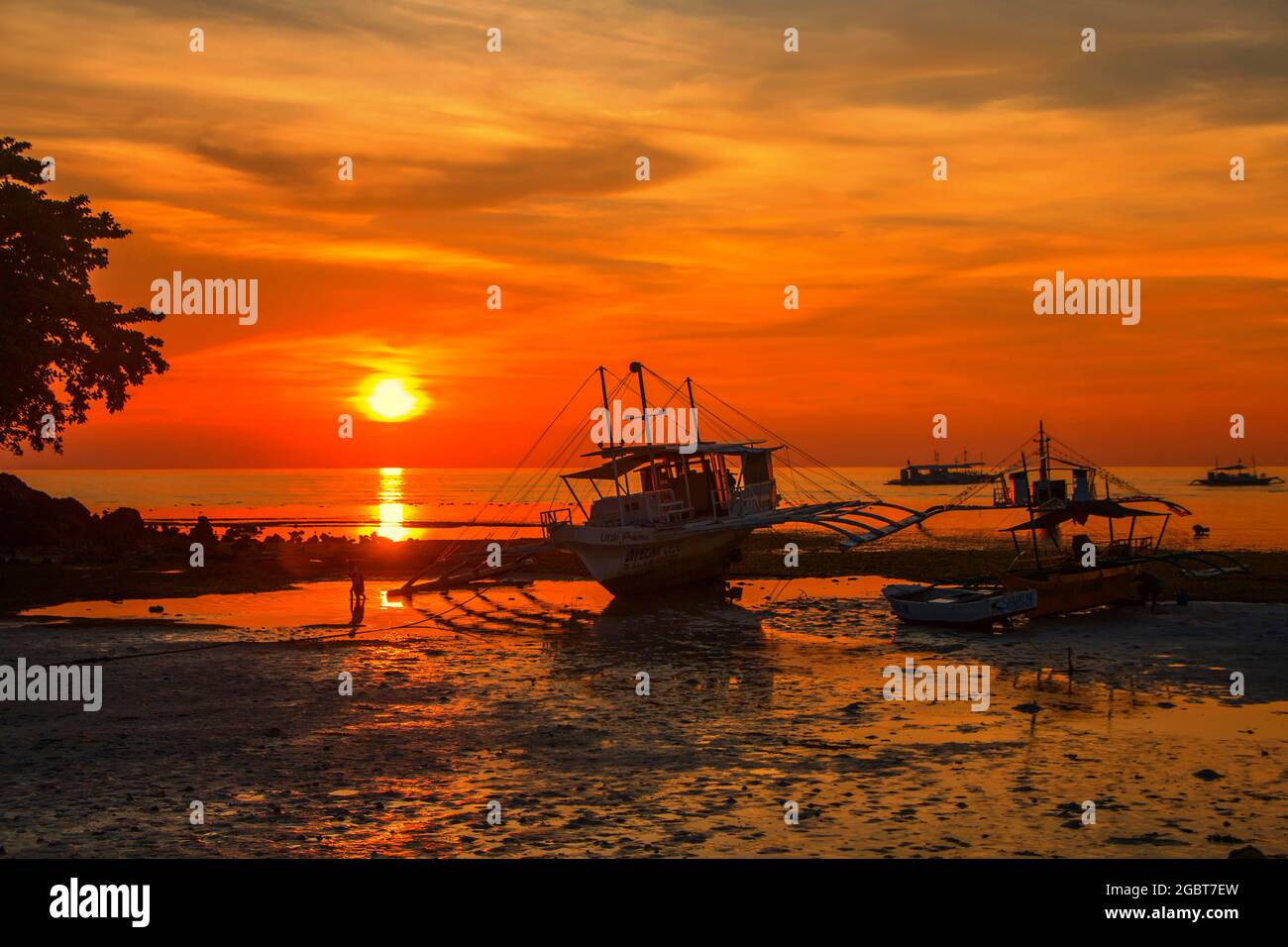 boat on a beach at sunset in philippines Stock Photo - Alamy