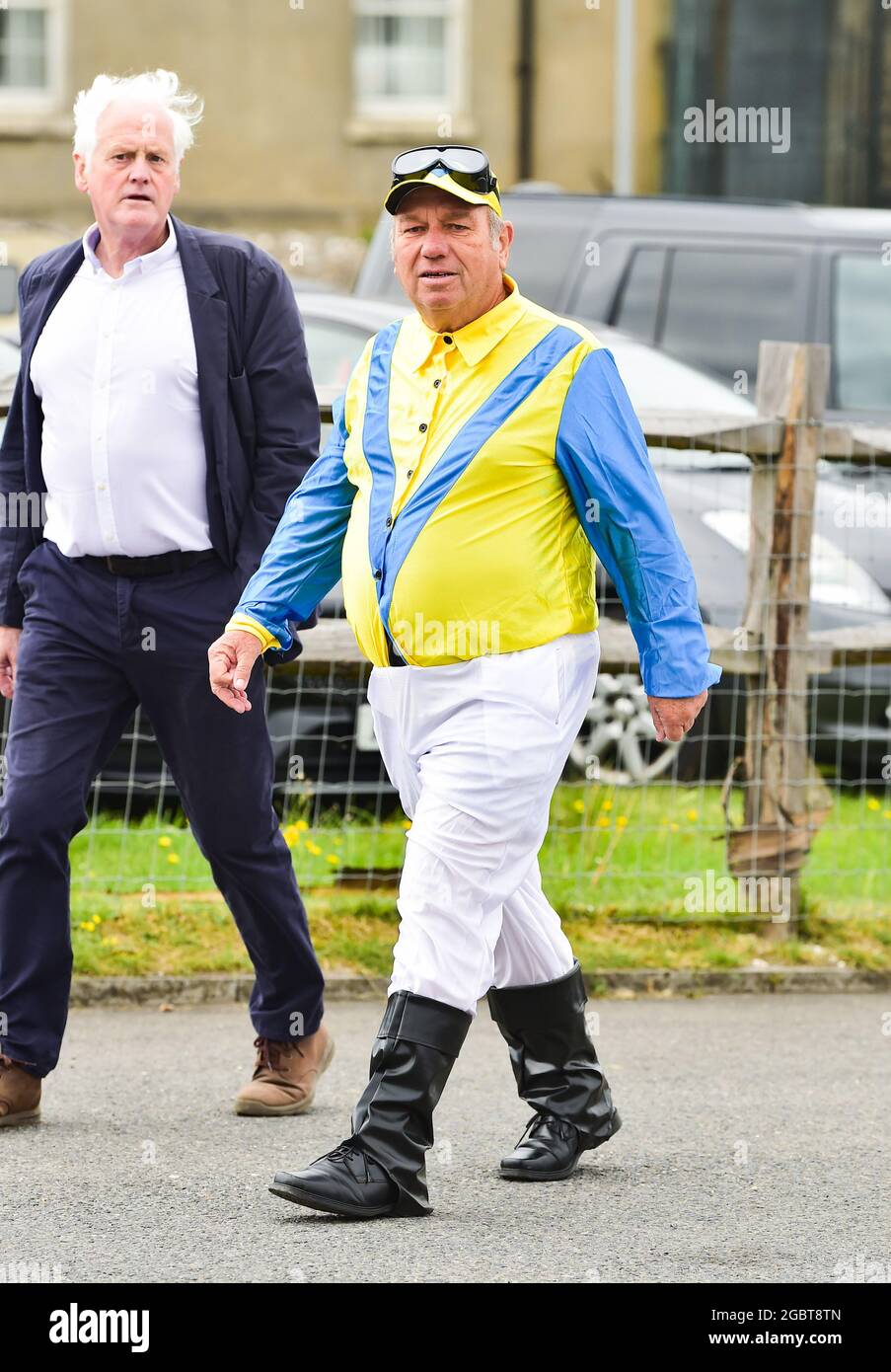 Brighton UK 5th August 2021 - This punter wearing an appropriate outfit as they arrive for Brighton Races Ladies Day on a breezy afternoon  : Credit Simon Dack / Alamy Live News Stock Photo