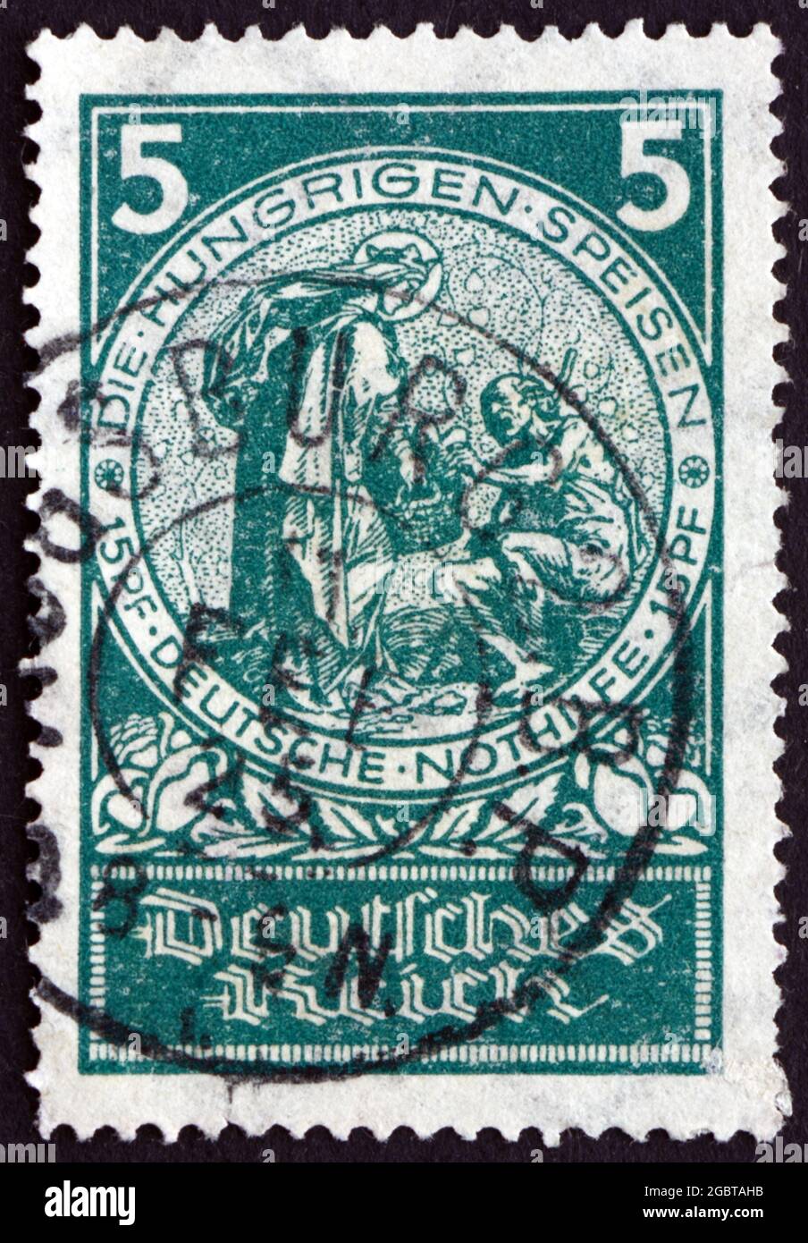 GERMANY - CIRCA 1924: a stamp printed in the Germany shows Feeding the Hungry, Social Welfare, circa 1924 Stock Photo