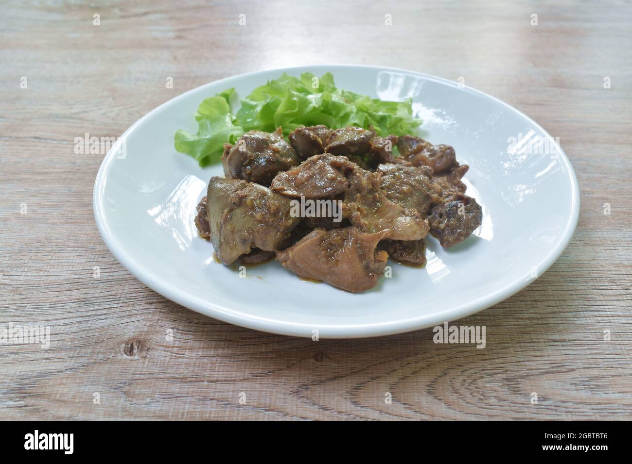 fried chicken liver and gizzard with pepper couple garlic on plate