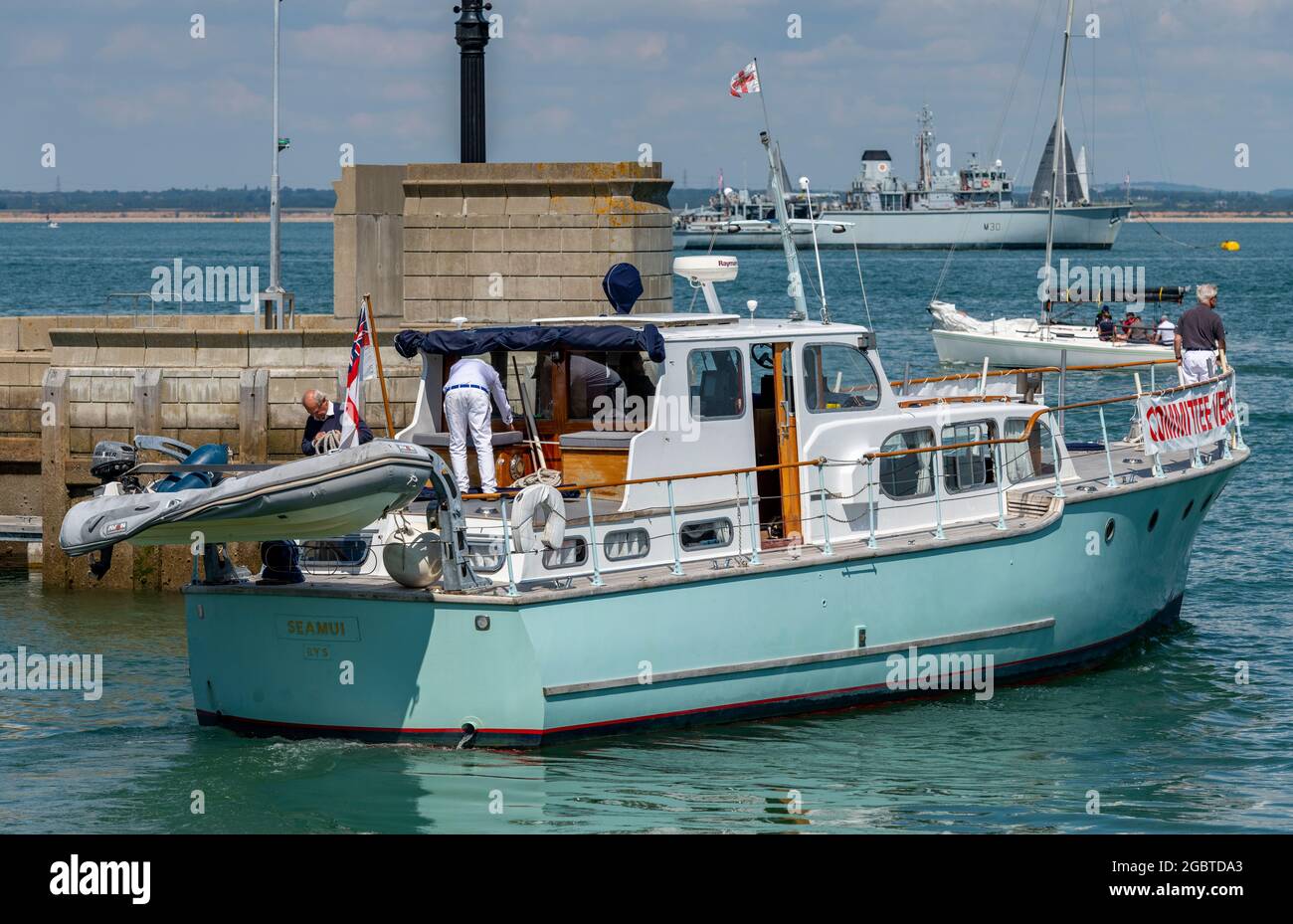 committee boat at cowes wee yachting regatta on the isle of wight, cowes week yacht racing, committee boat start line at cowes week, royal yacht club. Stock Photo