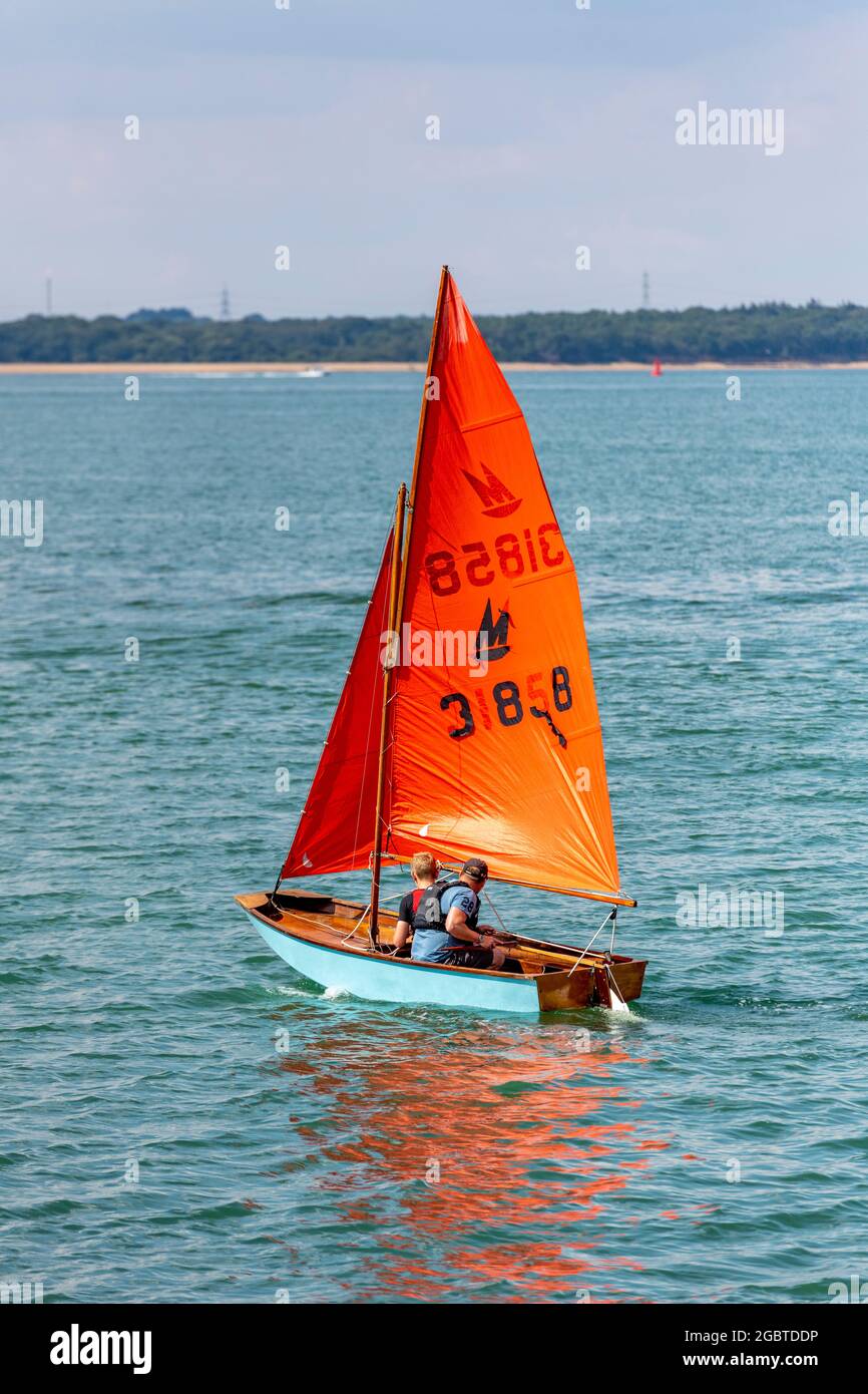 mirror sailing dinghy with crew off of cowes during cowes week on the isle of wight, uk Stock Photo