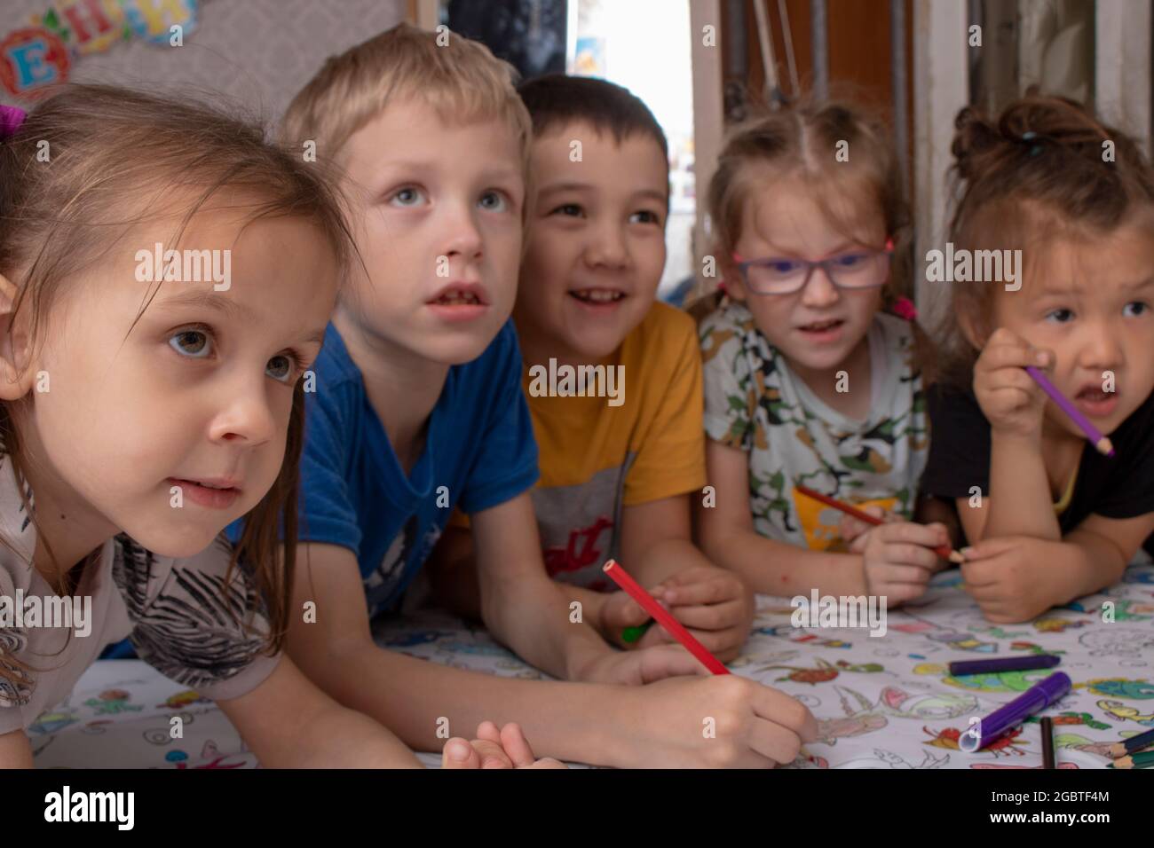 children painting with penclis, crayons on table Stock Photo