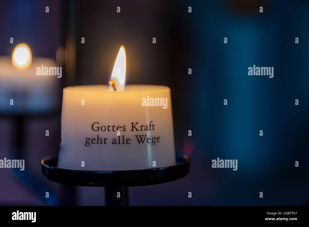 Candle with the German script Gods power goes all ways Stock Photo Alamy