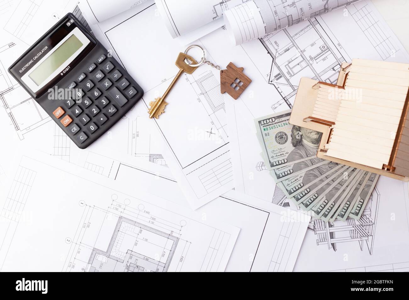 drawings of the house, dollars and a wood house, calculator and keys to