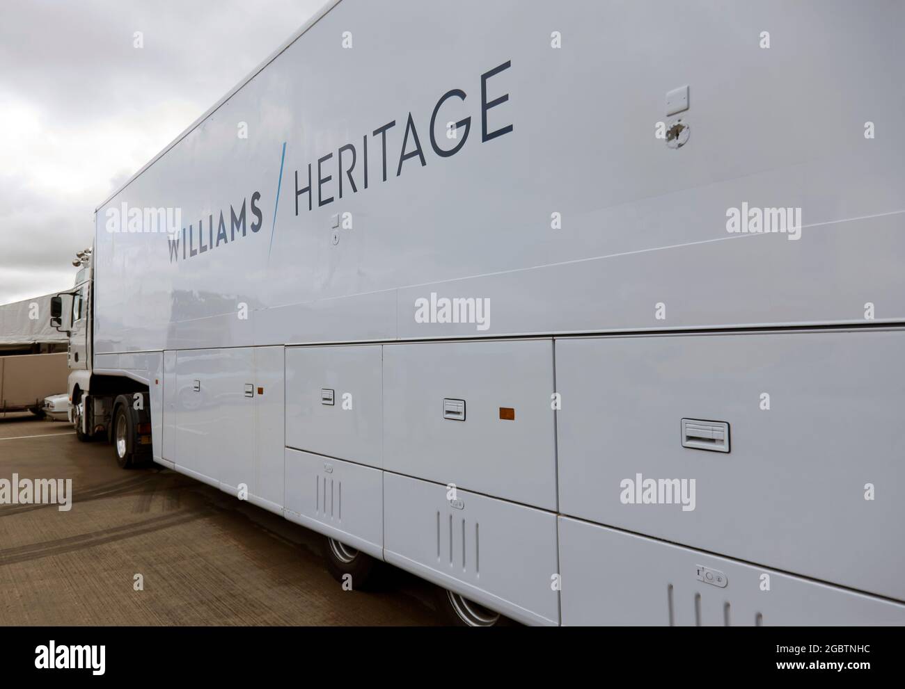 The Williams Heritage Team Transporter parked next to Pit garage 27, in the International Paddock, on Sunday, at the 2021 Silverstone  Classic Stock Photo