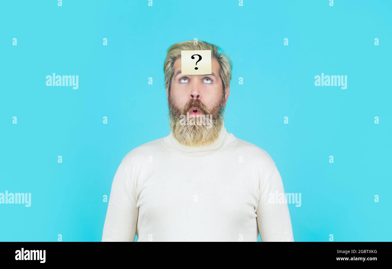 Thinking bearded man with on blue background. Man with question mark on forehead looking up. Paper notes with question Beard man Stock Photo - Alamy