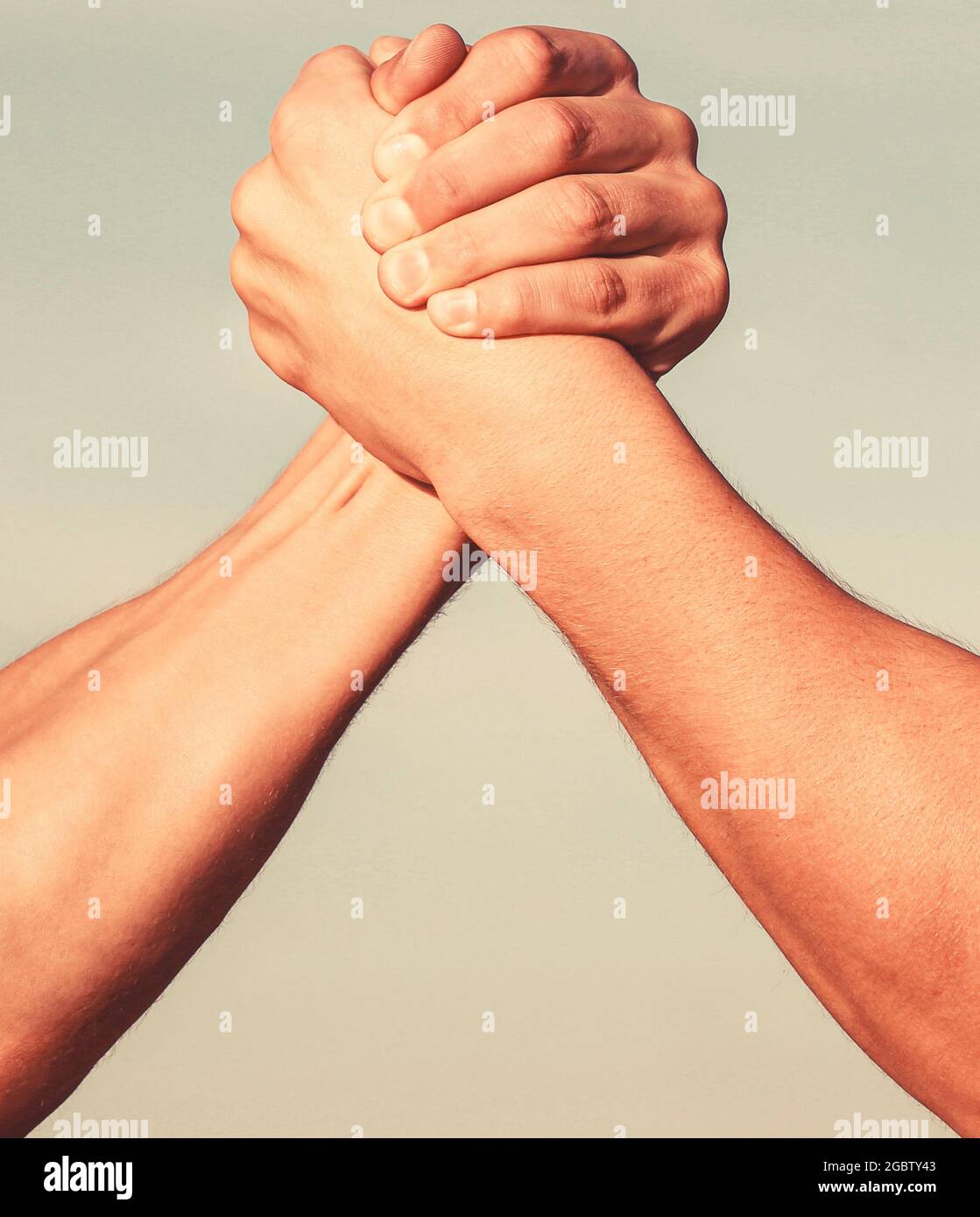 Two men arm wrestling. Arms wrestling. Closep up. Friendly handshake