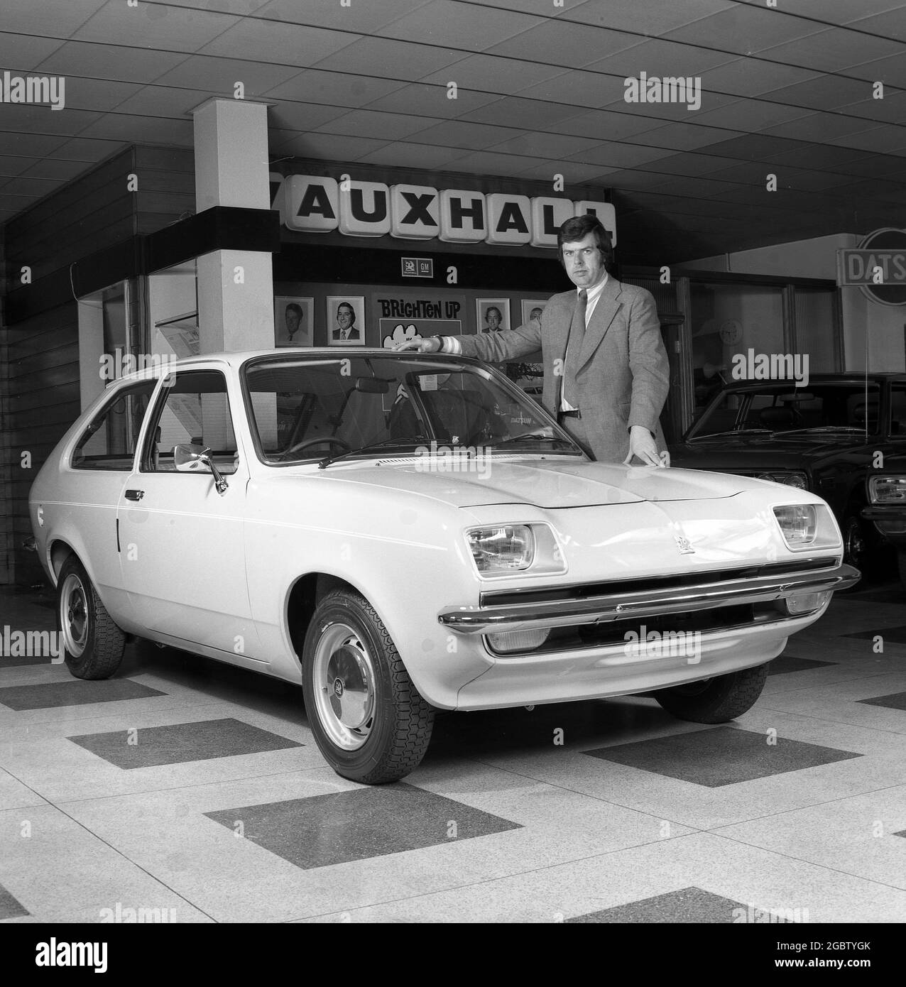 1975, historical, a car salesman standing by a small Vauxhall hatchback motorcar inside a showroom, Croydon, England, UK. Stock Photo