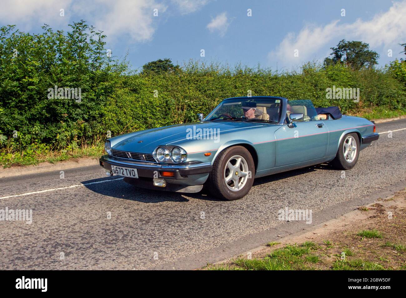 1990 90s blue Jaguar HE 3 speed automatic 5343cc petrol 2dr cabrio en-route to Capesthorne Hall classic July car show, Cheshire, UK Stock Photo