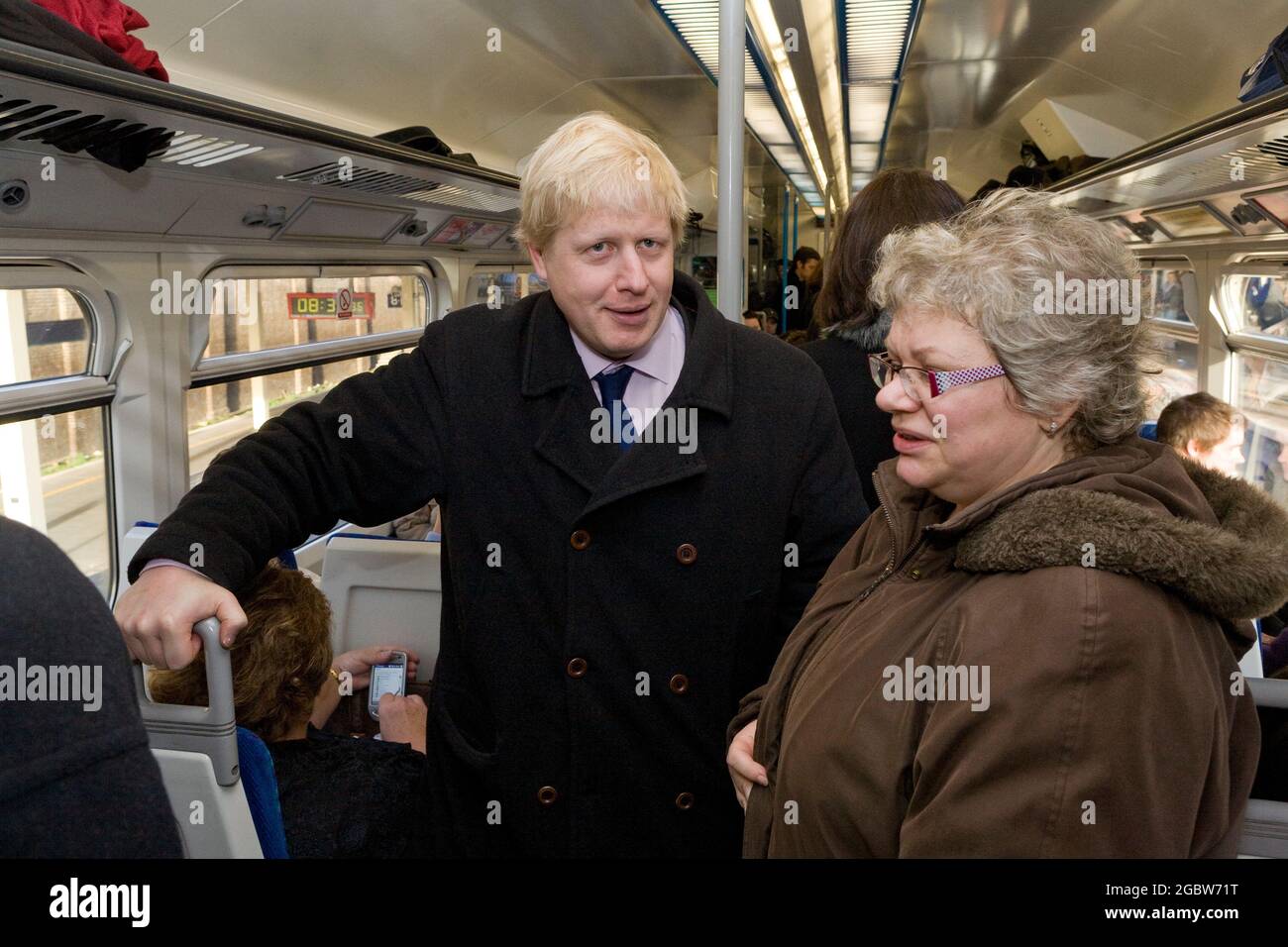 Boris Johnson, conservative candidate for Mayor of London traveling up to Waterloo East on 7.56 from Crayford. Talking with regular commuter Alicja Chapman from Sidcup. His journey was to see what traveling conditions are like for rail commuters coming from southern suburbs into central London.  London, UK.  25 Feb 2008 Stock Photo