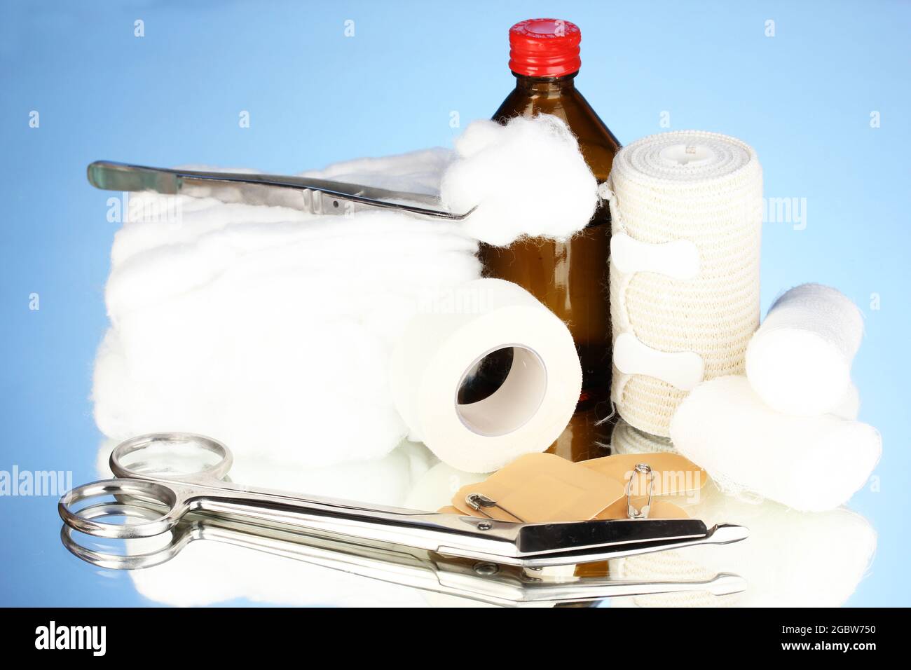 First aid kit for bandaging on blue background Stock Photo - Alamy