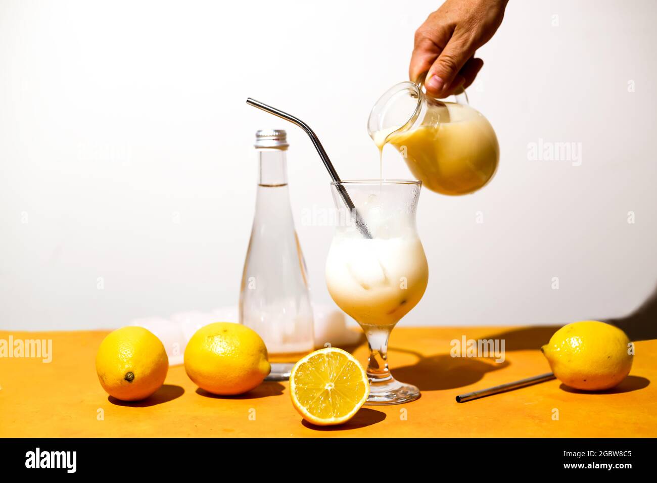 Creamy lemonade trendy summer mocktail. Cold non-alcoholic cocktail with lemon juice and sweetened condensed milk. Ingredients for prepare delicious b Stock Photo