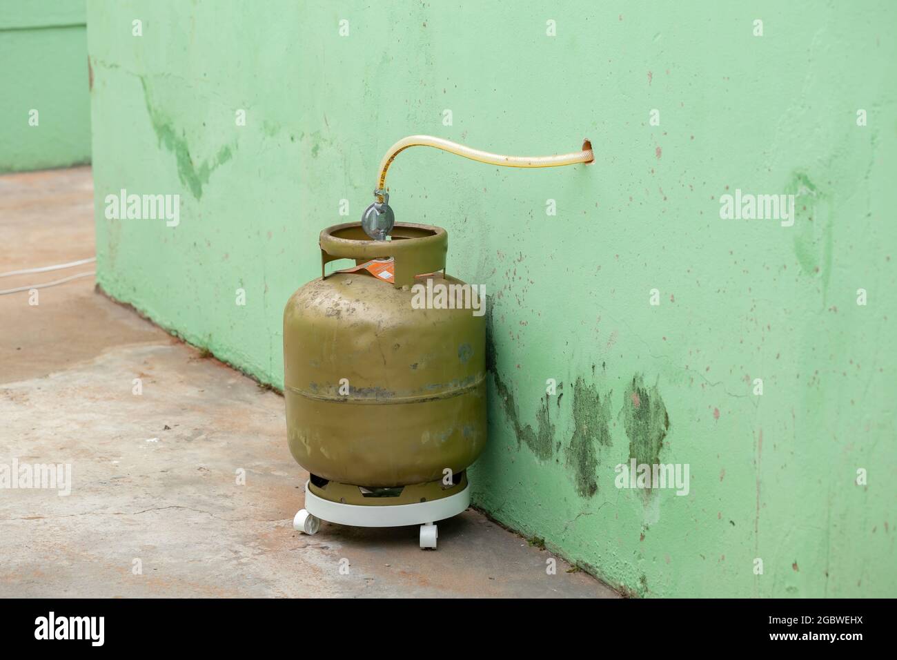 Kitchen gas canister outside the house by hole in the kitchen wall