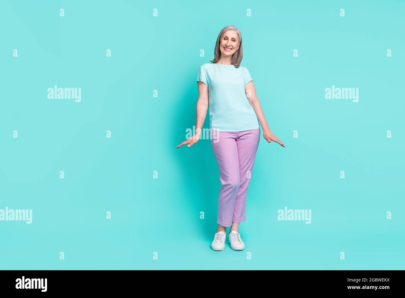 Full size photo of gorgeous stunning mature woman grandma enjoying summer  vacation isolated on teal color background Stock Photo - Alamy