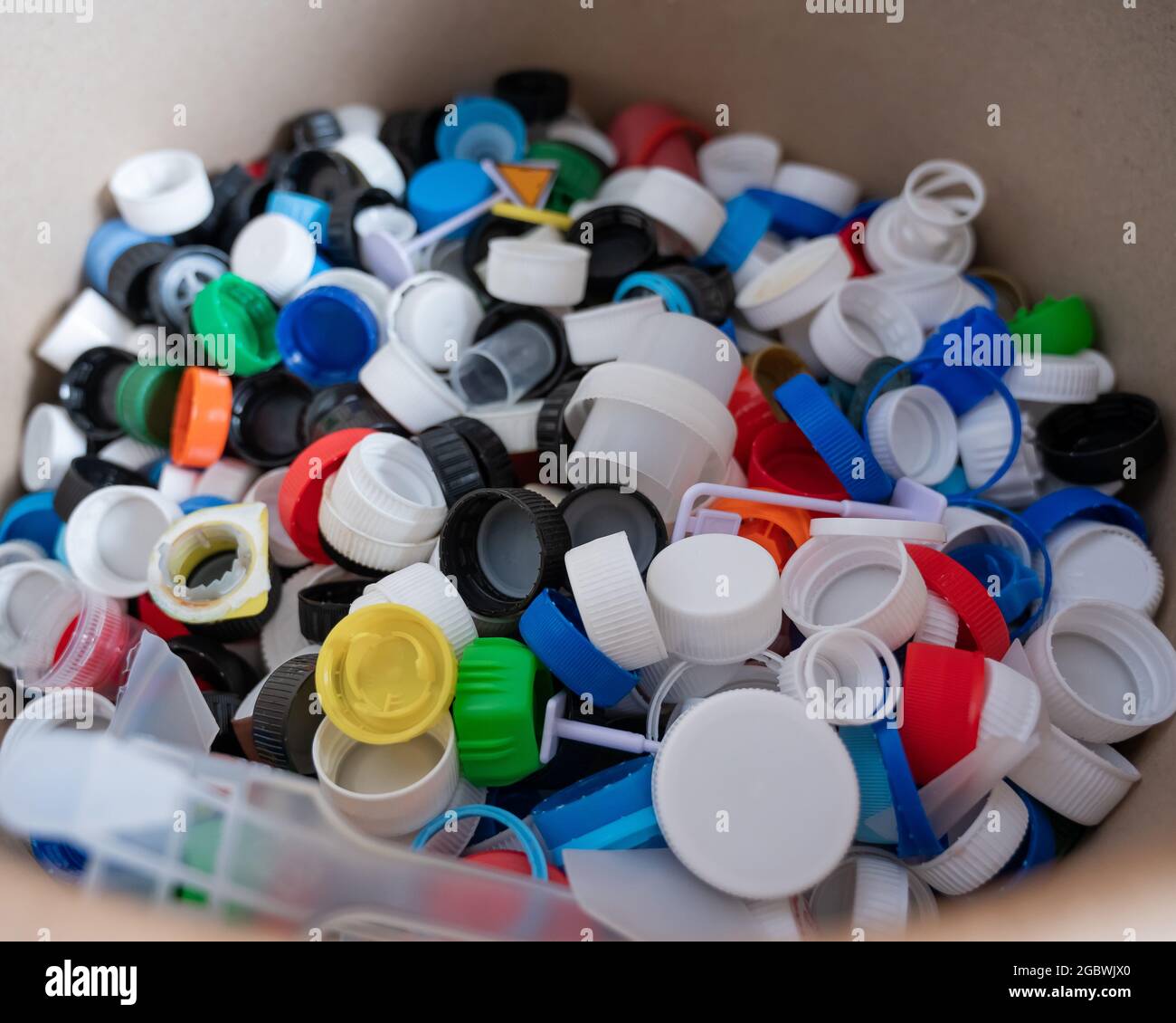 A closeup of many plastic bottle caps collected for recycling Stock