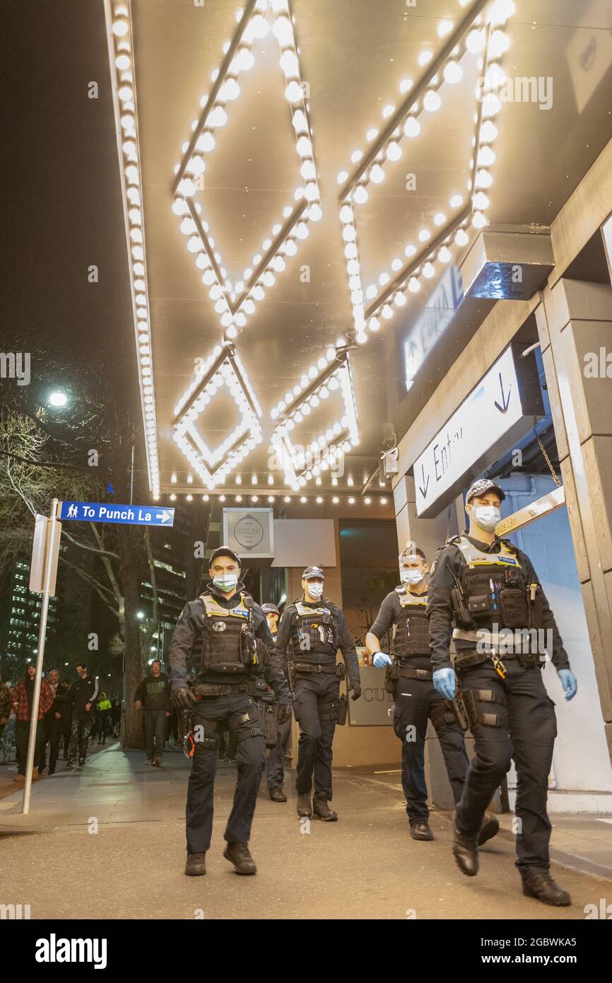 Melbourne, Australia. 5th Aug, 2021. Police officers walk past 'Punch Lane' during an anti-lockdown protest. Unhappy at the recent announcement that Victoria's sixth lockdown would commence later that night, a snap protest took place going beyond the 8pm cut off time. Credit: Jay Kogler/Alamy Live News Stock Photo