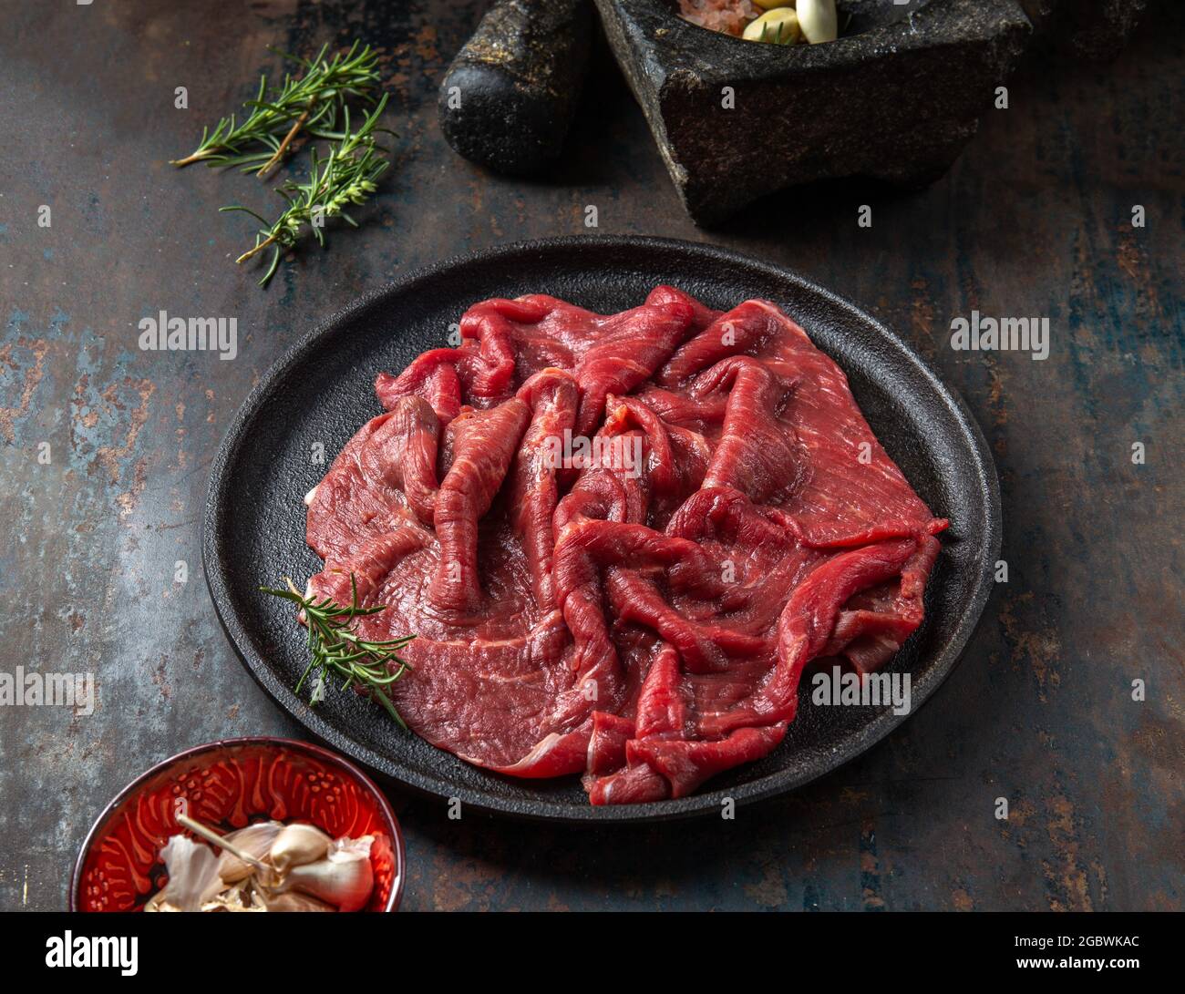Beef tenderloin with herbs and spices on cast iron plate Stock Photo