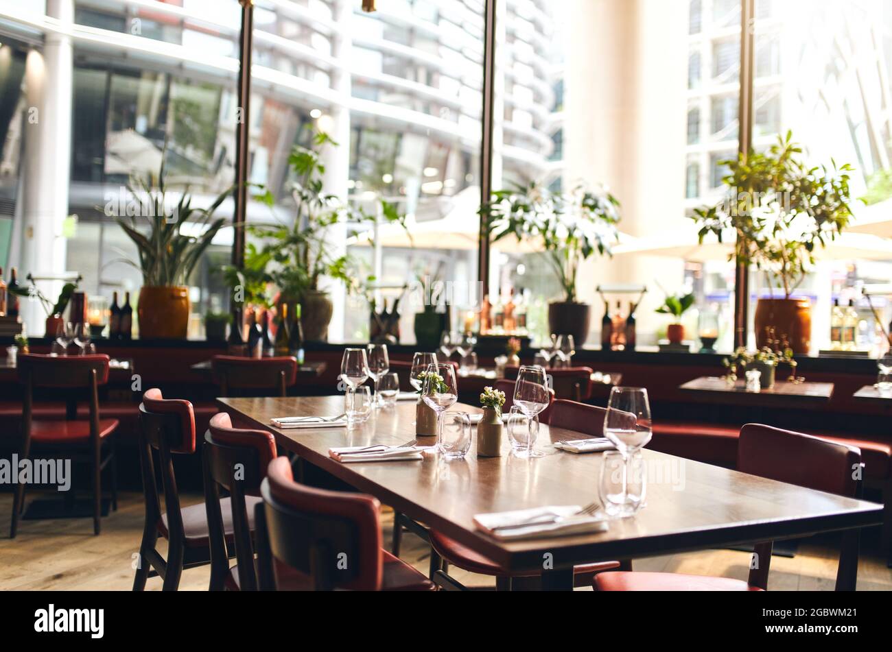 Tables set for dinner in restaurant Stock Photo - Alamy
