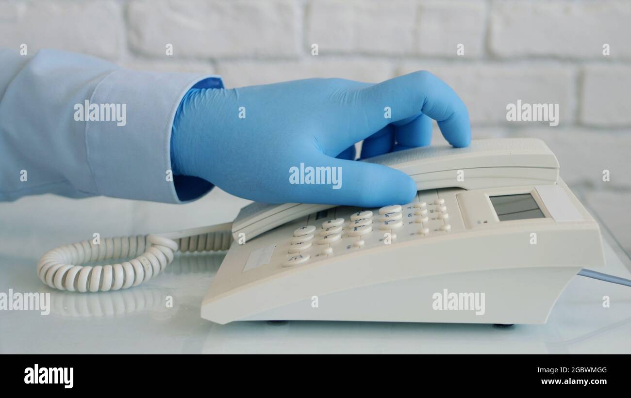 Image with Businessman Hands Wearing Protective Gloves Using Telephone Stock Photo