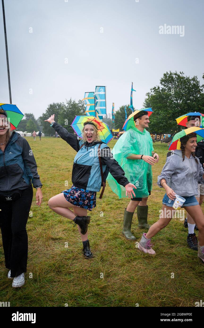 Wilderness Festival, Oxfordshire, UK. 5th Aug, 2021. Revellers dressed up and ready to enjoy Wilderness Festival despite the rain as the event starts its 10th year. It was postponed in 2020 due to Covid, but has been able to go ahead in 2021 with strict testing in place. Credit: Andrew Walmsley/Alamy Live News Stock Photo